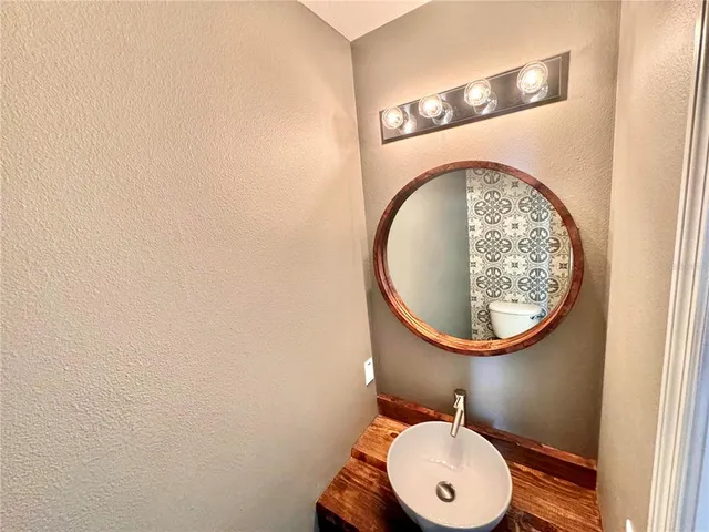 a bathroom with a toilet and a mirror