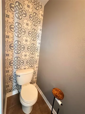 a white toilet sitting next to a small bathroom
