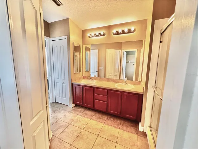 a spacious bathroom with a mirror a sink and a mirror