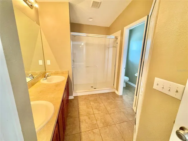 a view of a bathroom with tub and shower