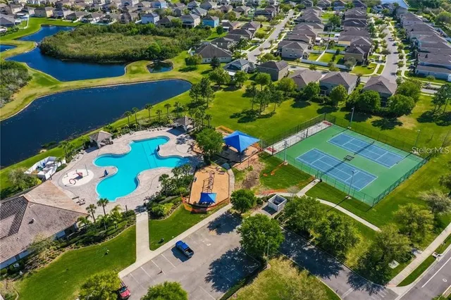 an aerial view of a residential houses with outdoor space and street view