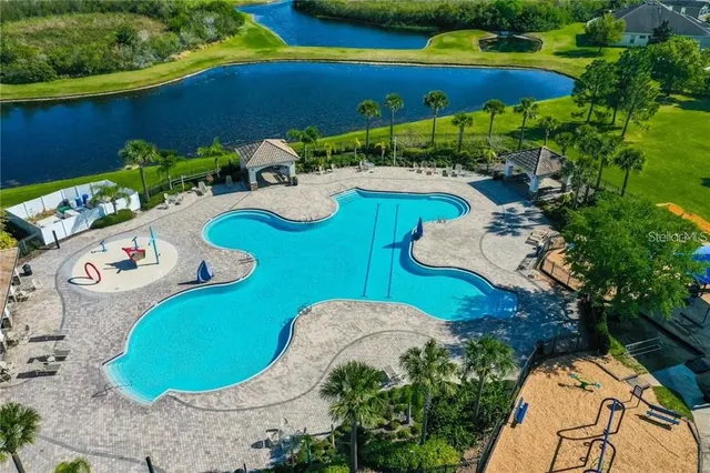 a view of a swimming pool with outdoor seating