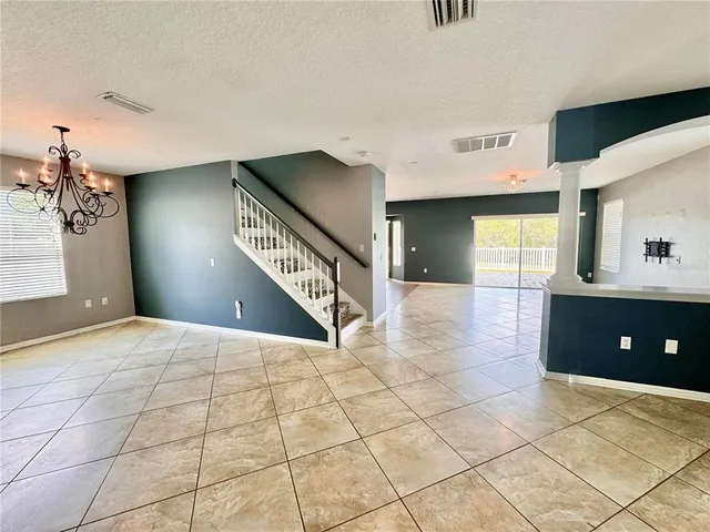 a view of a hallway with windows and stairs