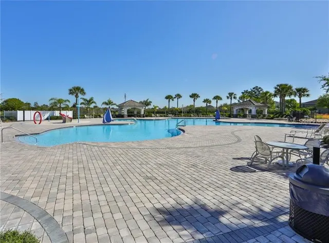 a view of a lake with chairs