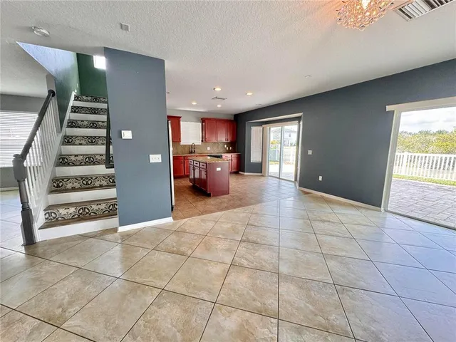 a view of a livingroom with furniture and staircase