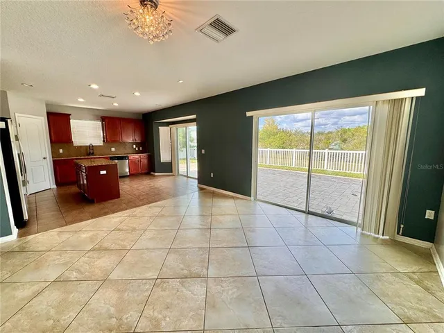 a open kitchen with stainless steel appliances granite countertop a refrigerator and a sink