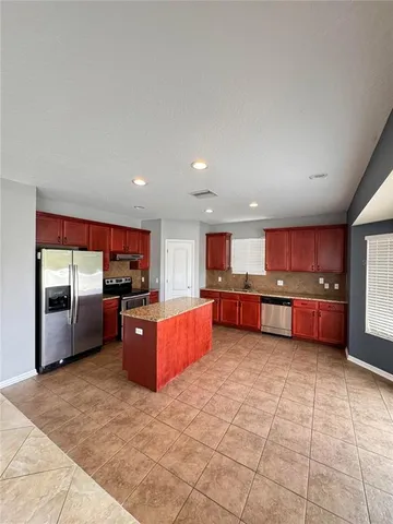a kitchen with stainless steel appliances lots of counter top space