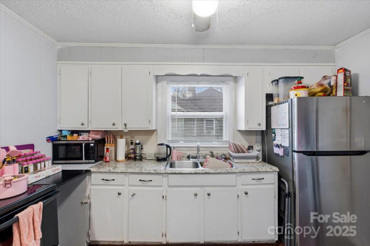 401 North Myrtle Street Gastonia, NC 28052 - Photo 6 of 14 a kitchen with stainless steel appliances granite countertop a refrigerator sink and cabinets