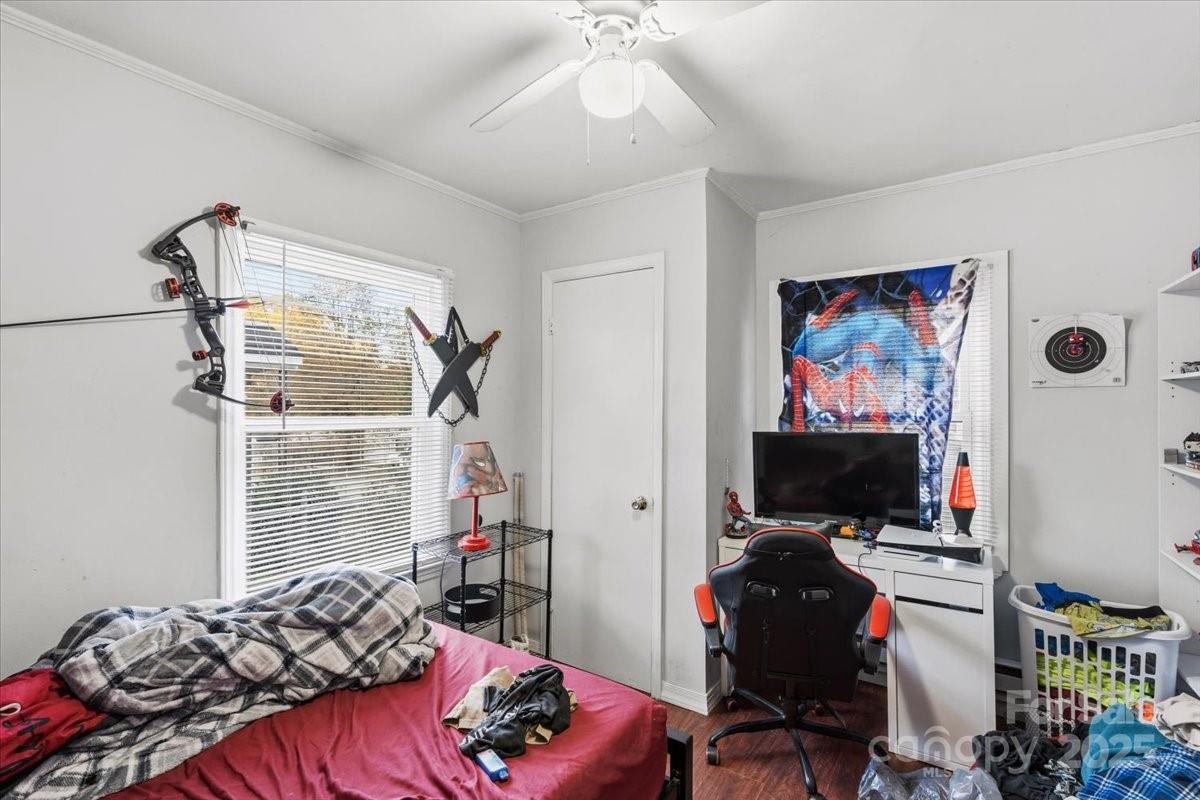 401 North Myrtle Street Gastonia, NC 28052 - Photo 10 of 14 a bedroom with a bed and a flat screen tv