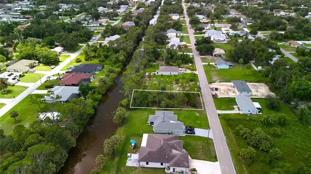 an aerial view of residential houses with outdoor space and swimming pool