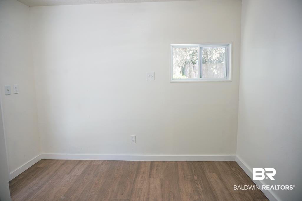 4159 Rebecca Road Mobile, AL 36609 - Photo 9 of 19 Empty room with wood finished floors and baseboards