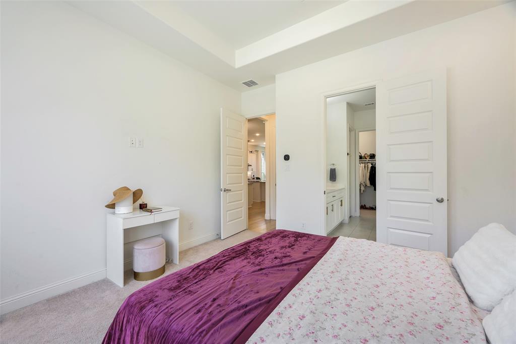 3603 Scotsman Road Sachse, TX 75048 - Photo 15 of 33 a bedroom with a bed and a refrigerator