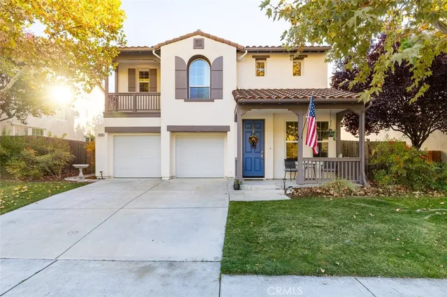 a view of a white house with a yard and large tree