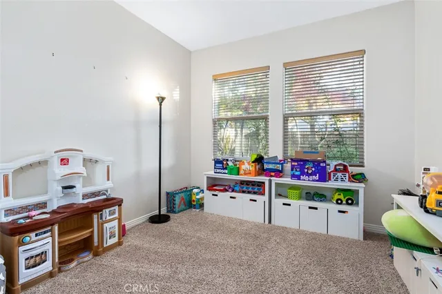 a bathroom with a granite countertop toilet sink and mirror