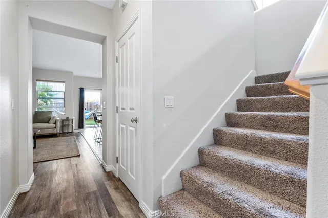 a view of a hallway with a window and wooden floor