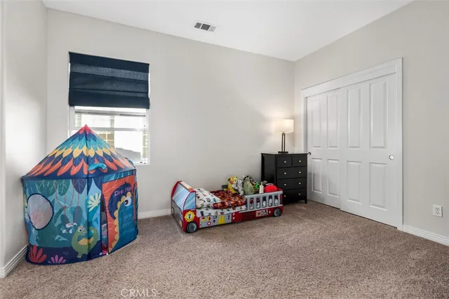 a bedroom with bed and a couch