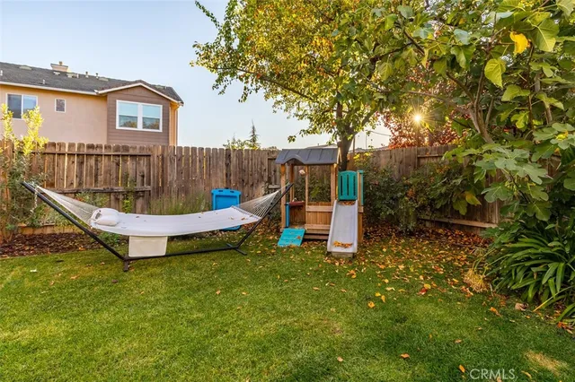 a backyard of a house with table and chairs