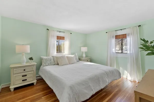 a bedroom with a bed and a potted plant