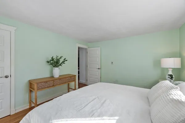 a bedroom with a bed and lamp