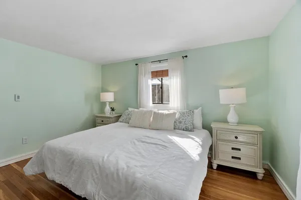 a bedroom with a bed and a potted plant