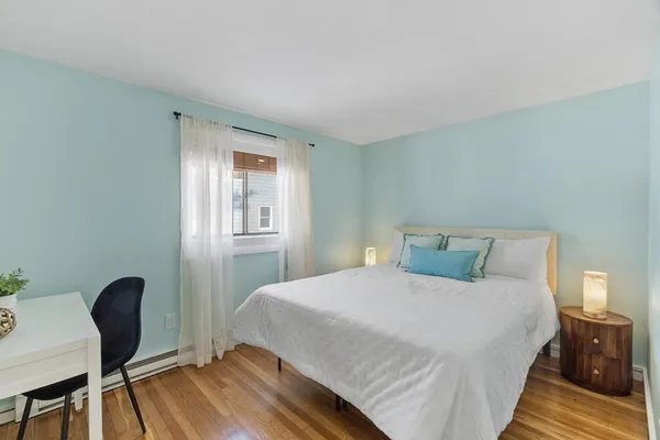 a bedroom with a bed and a chair