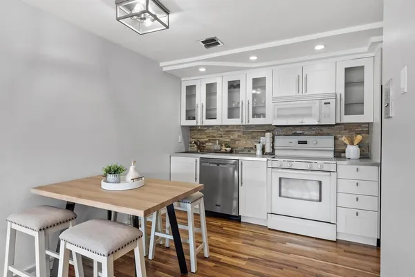 a kitchen that has a stove and a table