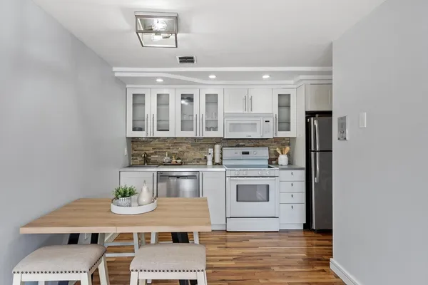 a kitchen with stainless steel appliances granite countertop a sink and cabinets