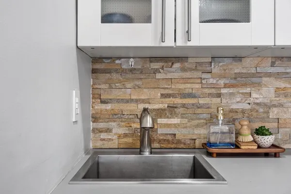 a kitchen that has a sink and a stove