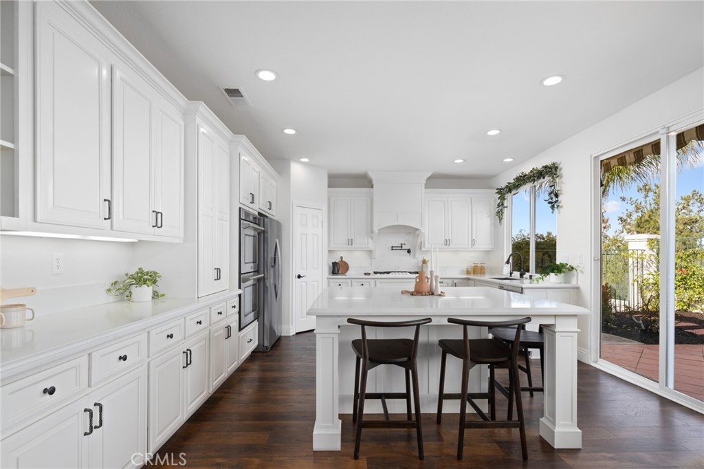 45644 Camino Rubi Temecula, CA 92592 - Photo 9 of 51 a kitchen with stainless steel appliances kitchen island granite countertop a table and chairs