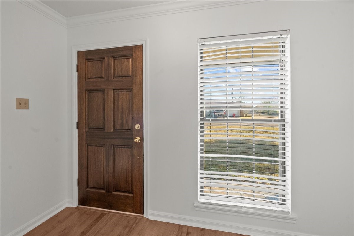 105 Alice Street Anahuac, TX 77514 - Photo 22 of 39 a view of wooden floor and windows in a room