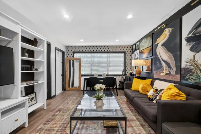 a living room with furniture fireplace and a rug