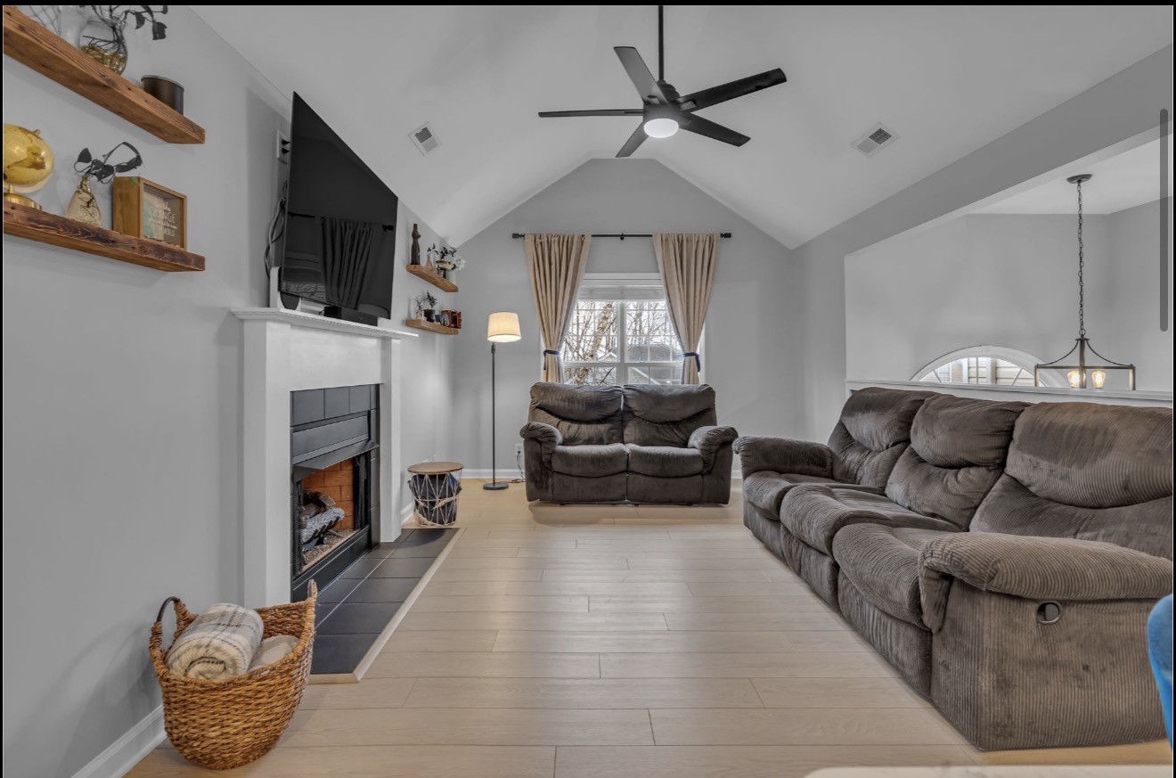 1589 Hedgewood Road Clarksville, TN 37042 - Photo 12 of 30 a living room with furniture a fireplace and a flat screen tv