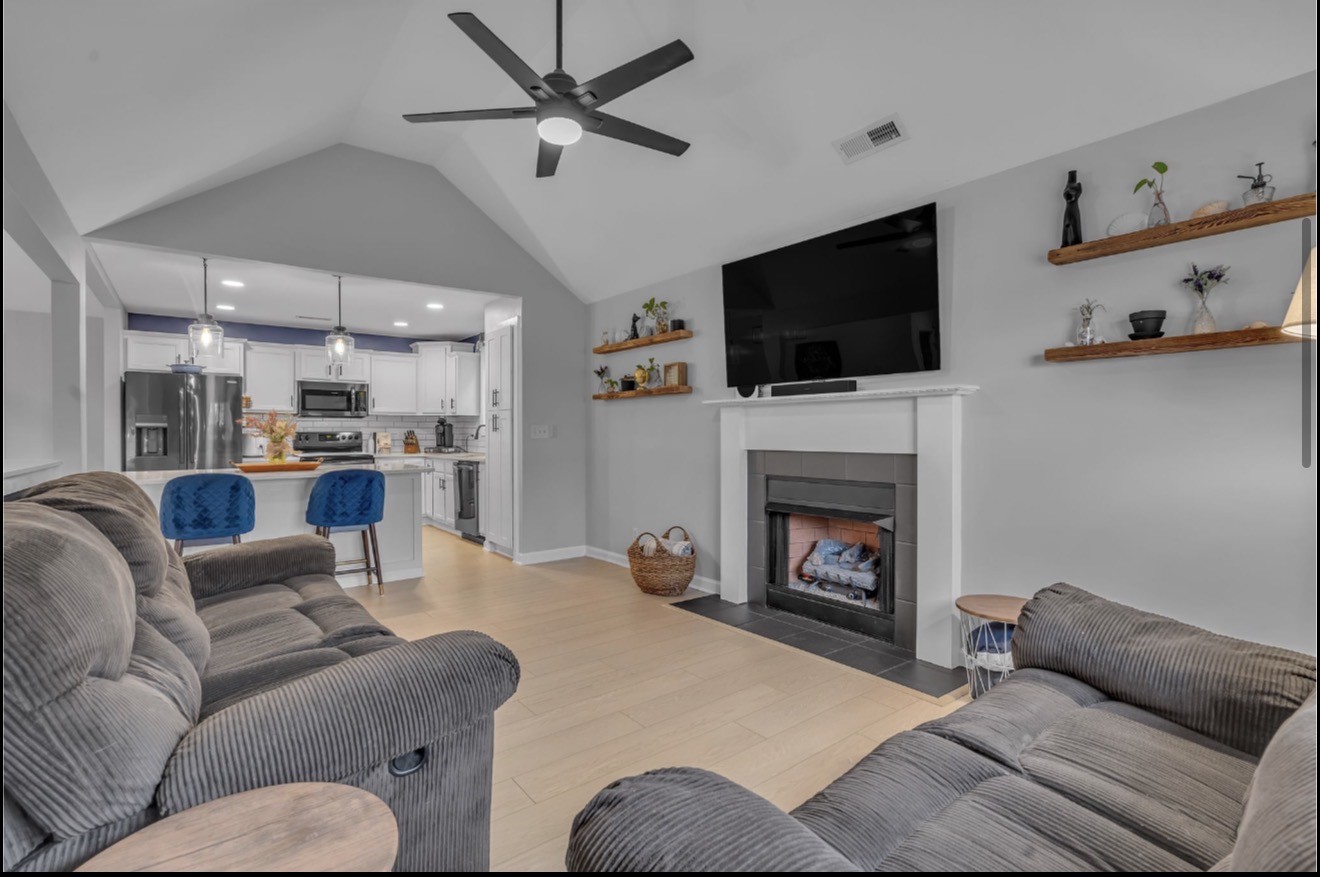 1589 Hedgewood Road Clarksville, TN 37042 - Photo 13 of 30 a living room with furniture a flat screen tv and a fireplace