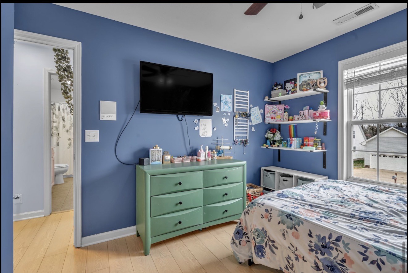1589 Hedgewood Road Clarksville, TN 37042 - Photo 20 of 30 a bedroom with a bed and a flat screen tv