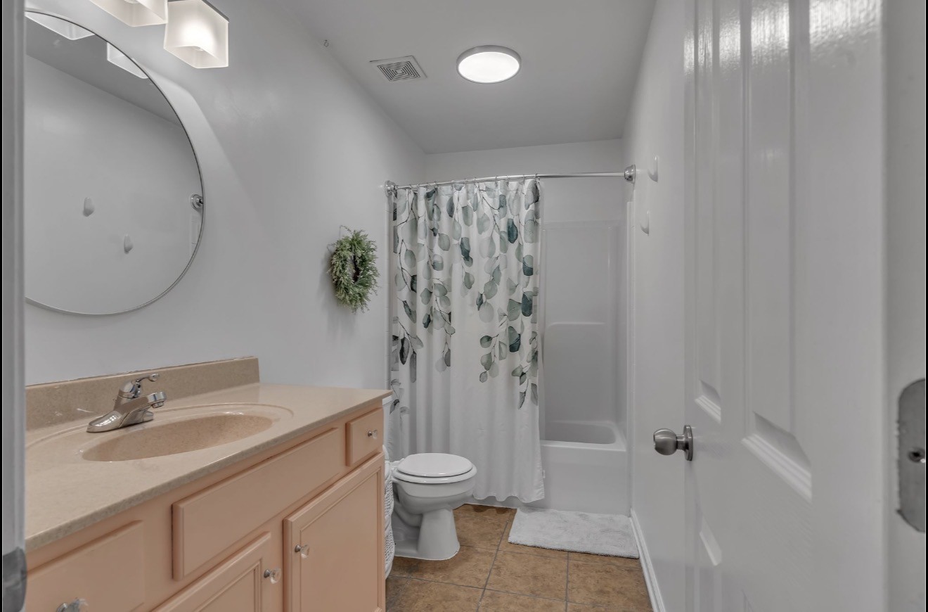 1589 Hedgewood Road Clarksville, TN 37042 - Photo 21 of 30 a bathroom with a granite countertop sink a toilet and shower