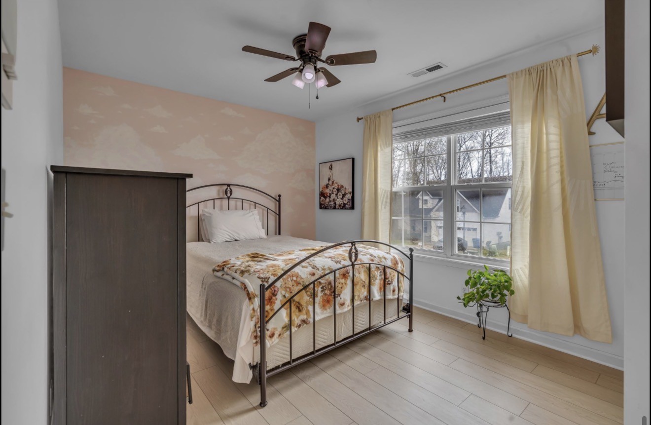 1589 Hedgewood Road Clarksville, TN 37042 - Photo 23 of 30 a bedroom with a bed and a potted plant
