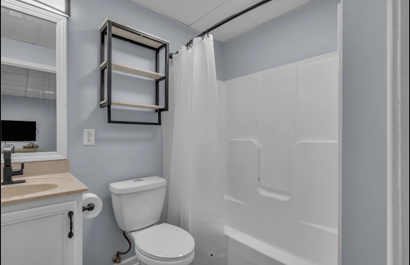 1589 Hedgewood Road Clarksville, TN 37042 - Photo 28 of 30 a bathroom with a toilet sink and mirror