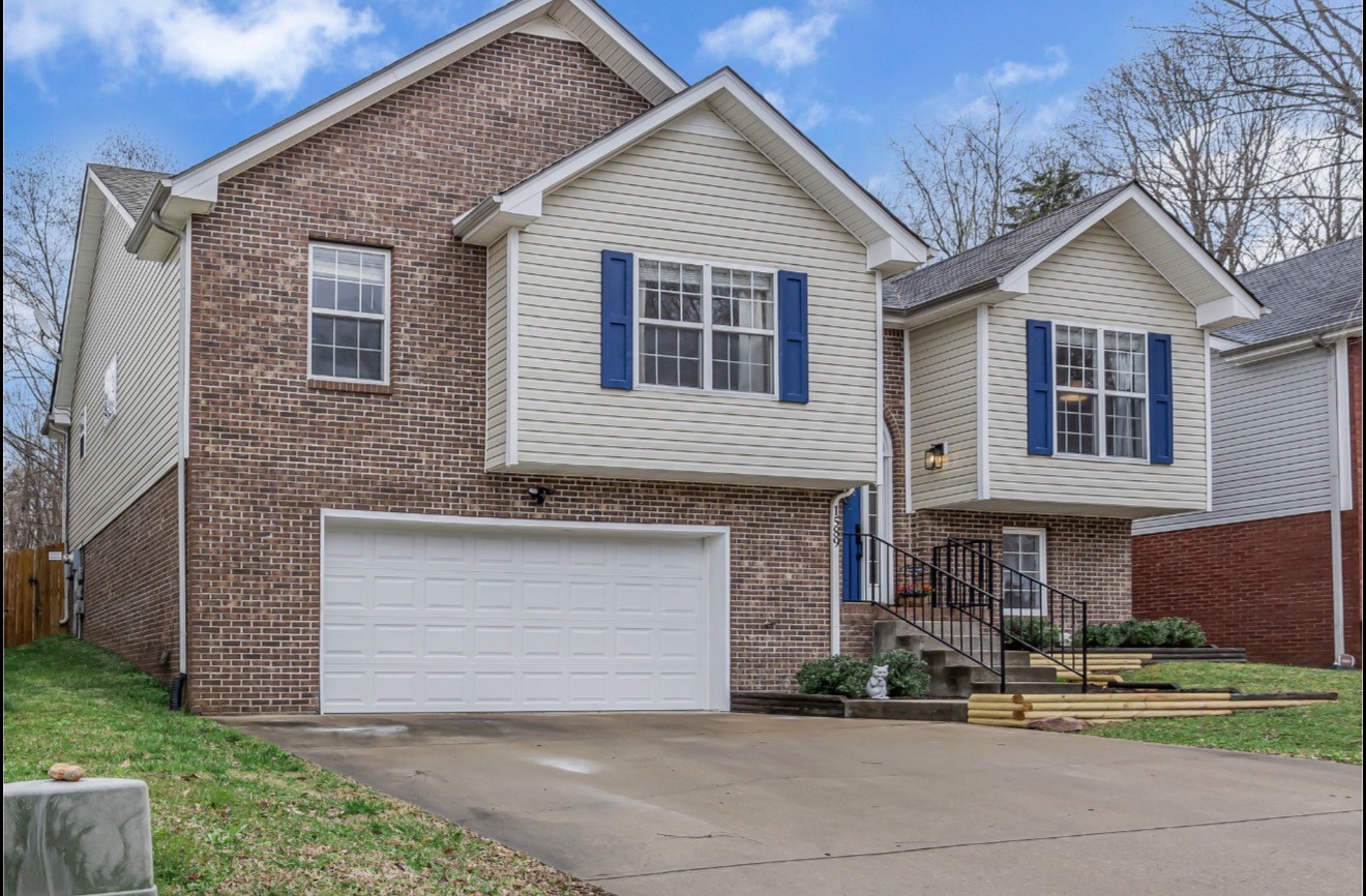 1589 Hedgewood Road Clarksville, TN 37042 - Photo 4 of 30 a front view of a house with a yard and garage