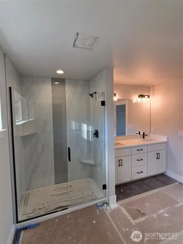a bathroom with a double vanity sink a toilet and a mirror
