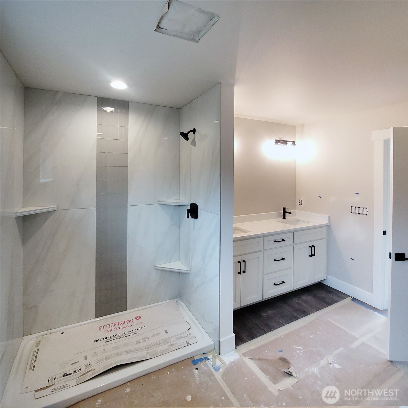 320 East 4th Street Union, WA 98592 - Photo 17 of 35 a bathroom with a double vanity sink and mirror with shower