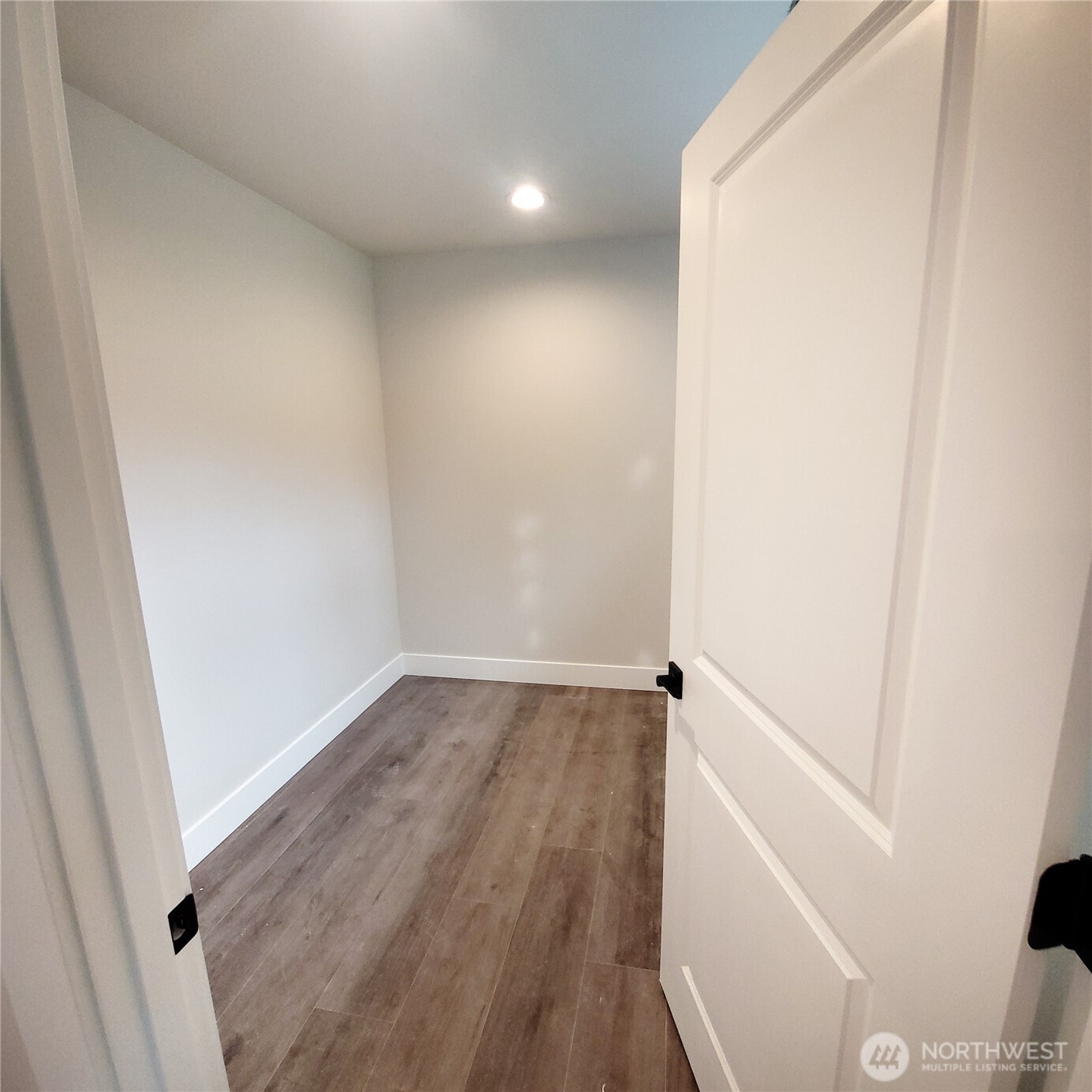320 East 4th Street Union, WA 98592 - Photo 19 of 35 an empty room with wooden floor and white walls