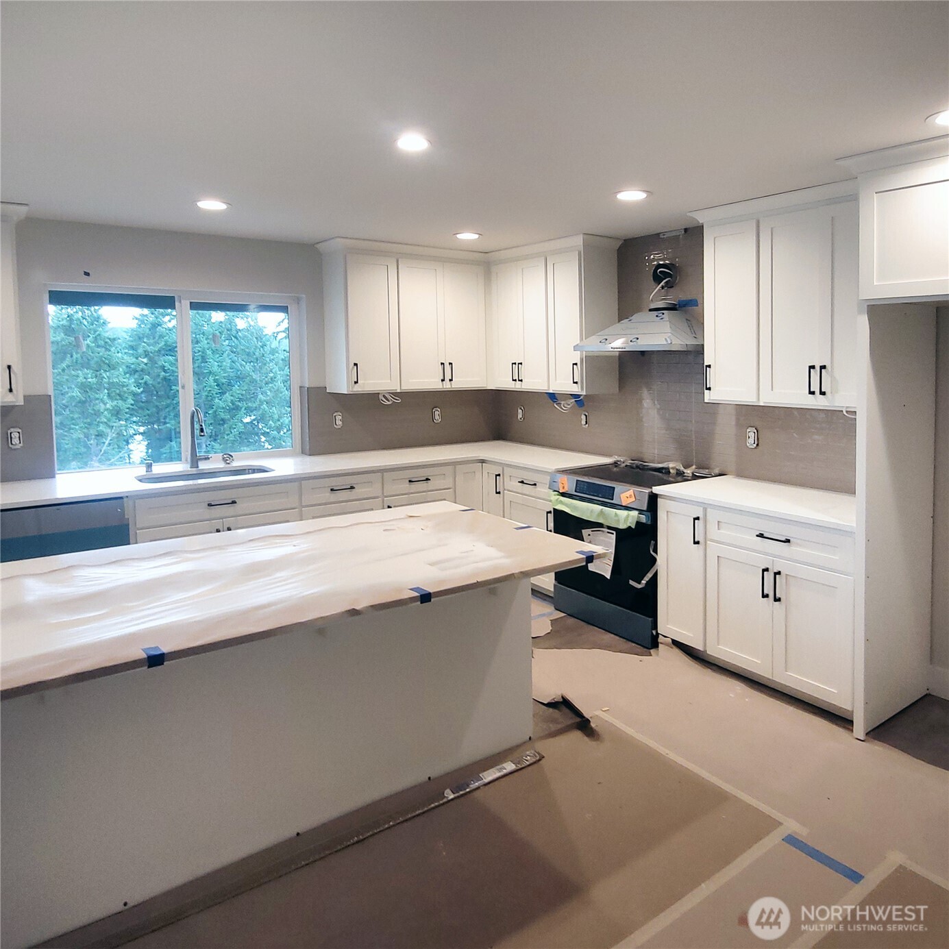 320 East 4th Street Union, WA 98592 - Photo 7 of 35 a kitchen with a sink window and cabinets