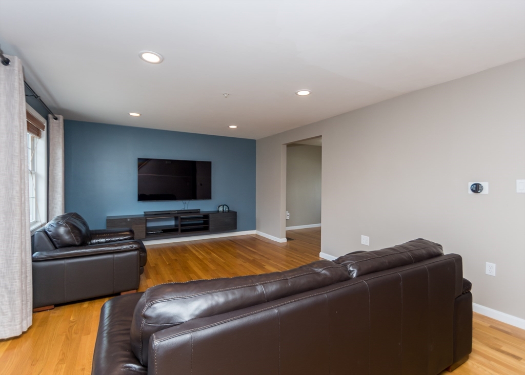 985 Trapelo Road, Unit 23 Waltham, MA 02452 - Photo 14 of 27 a living room with furniture and a flat screen tv