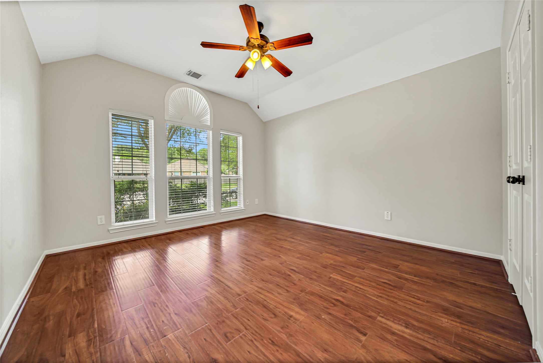 14526 Red Tailed Hawk Lane Houston, TX 77044 - Photo 27 of 40 an empty room with wooden floor and windows