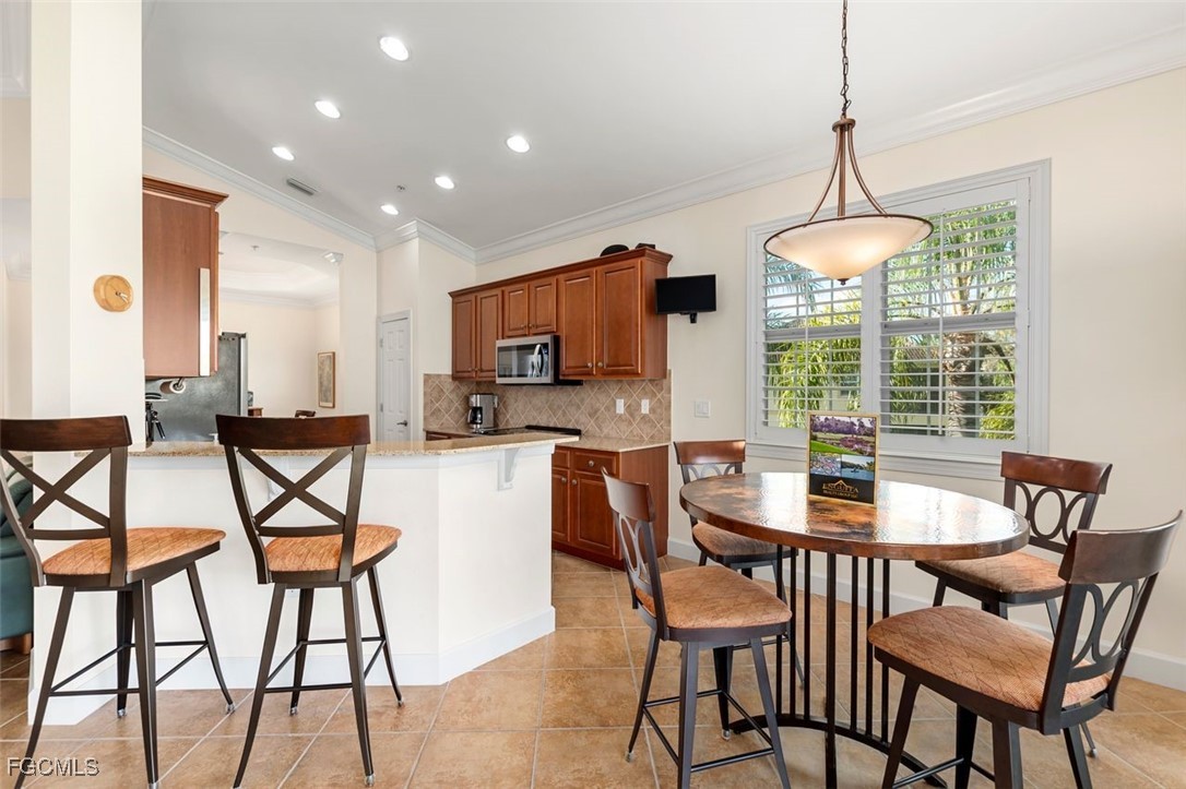 13071 Pebblebrook Point Circle, Unit 201 Fort Myers, FL 33905 - Photo 14 of 41 a dining room with furniture and window