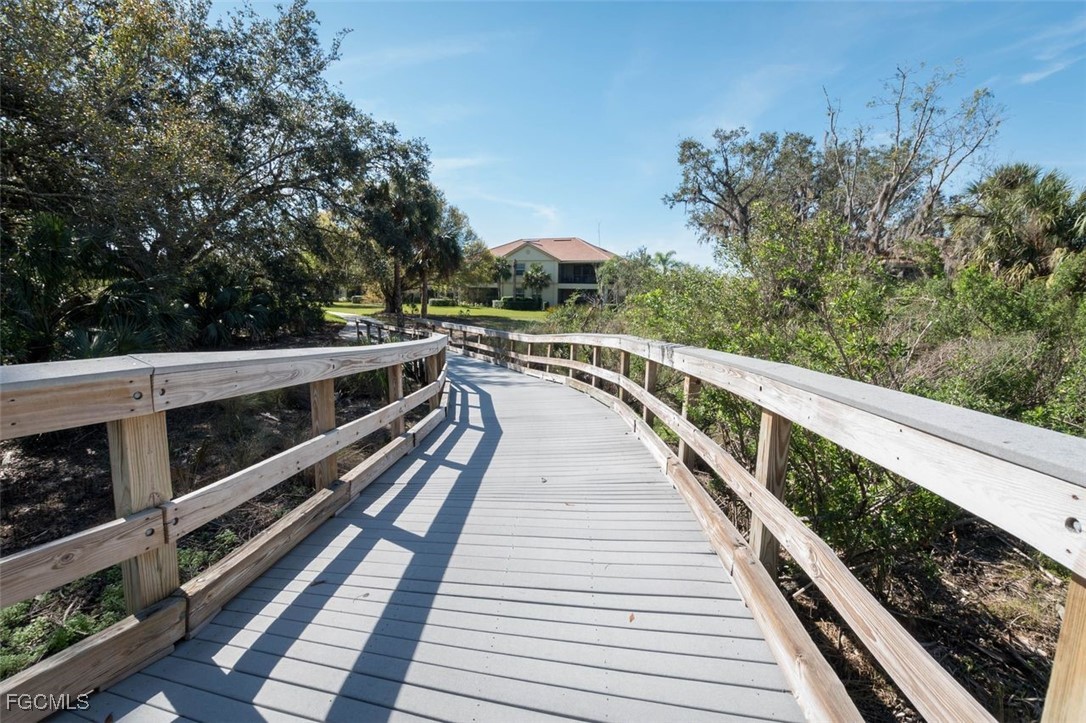 13071 Pebblebrook Point Circle, Unit 201 Fort Myers, FL 33905 - Photo 28 of 41 a view of a balcony with wooden floor and fence