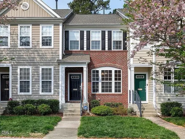 a front view of a house with garden and porch
