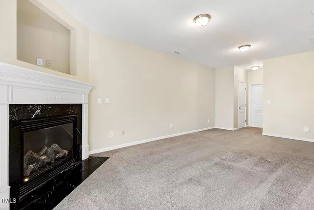 a view of an empty room with fire place