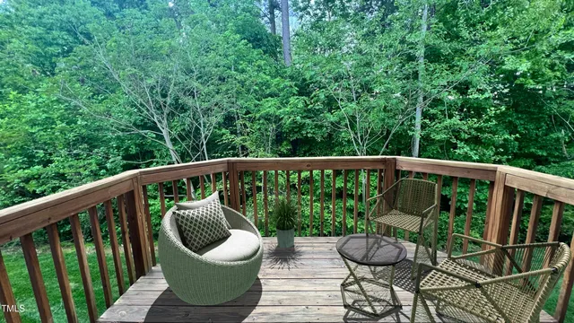 a view of a balcony with wooden floor and outdoor seating