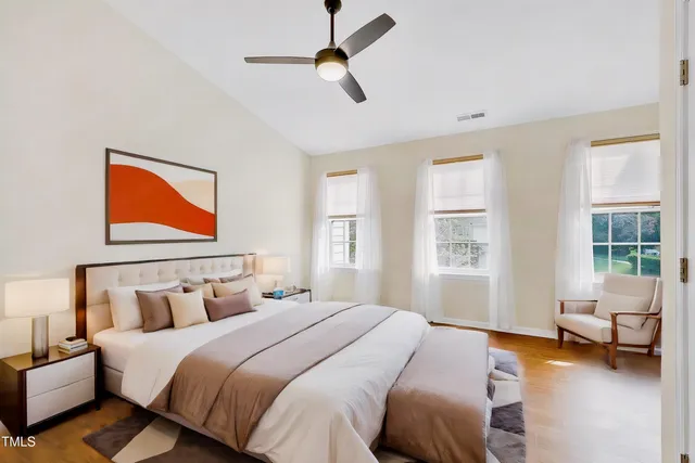 a bedroom with a bed a couch and a window